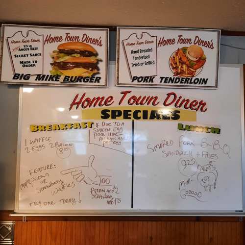 Menu board at Home Town Diner featuring specials for breakfast and lunch, including burgers and pork tenderloin.