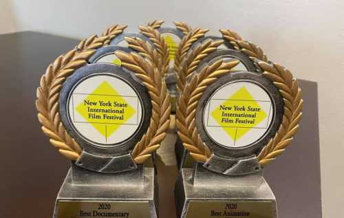 A row of trophies with laurel wreaths, labeled for the New York State International Film Festival 2020 awards.