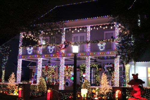 A beautifully decorated house at night, adorned with colorful Christmas lights and festive decorations.