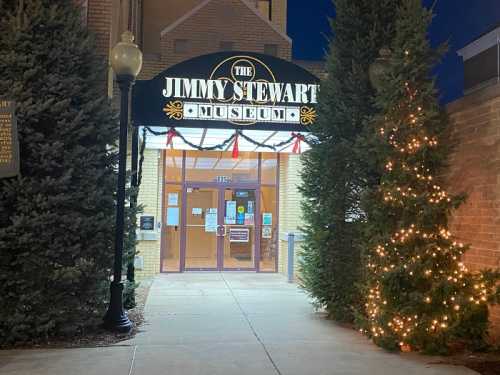 Entrance to the Jimmy Stewart Museum, decorated for the holidays with lights and festive greenery.