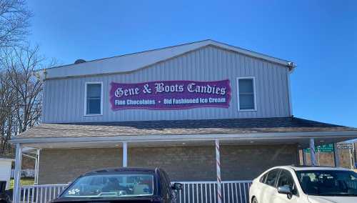 Sign on a building reads "Gene & Boots Candies" with a banner for fine chocolates and old-fashioned ice cream.