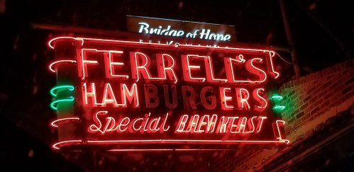 Neon sign for Ferrell's Hamburgers, featuring "Special Breakfast" in bright colors against a dark background.