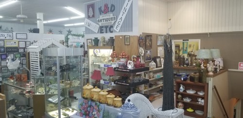 A cozy antique shop filled with various vintage items, displays, and decorative pieces.