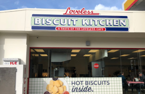 Sign for Loveless Biscuit Kitchen, featuring "Hot Biscuits Inside" and a welcoming storefront.