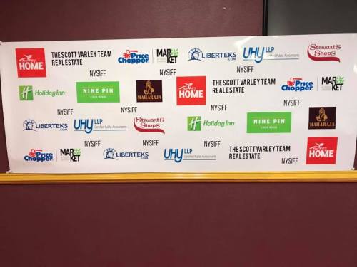 Banner featuring various logos, including The Scott Varley Team Real Estate, Holiday Inn, and Market, among others.