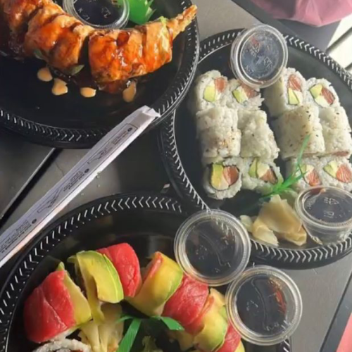 Three sushi platters featuring rolls, sashimi, and dipping sauces, garnished with wasabi and ginger.