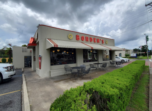 Exterior of Borden's restaurant with outdoor seating, cloudy sky, and nearby parked cars.