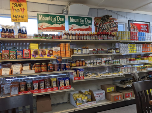 A grocery store aisle filled with various food products, snacks, and beverages on shelves.