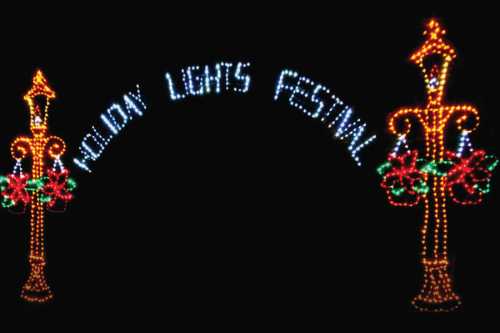 Colorful holiday lights form an archway with the text "Holiday Lights Festival" and decorative lanterns.