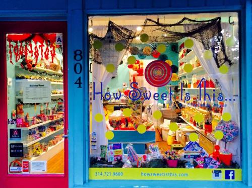 Colorful storefront of "How Sweet It Is," featuring candy displays and festive decorations.