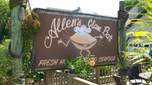 Sign for Allen's Clam Bar featuring a cartoon clam chef and the text "Fresh Hot Steamed Seafood."