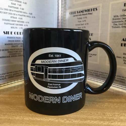 A black coffee mug featuring the logo of Modern Diner, established in 1941, with a drawing of the diner.