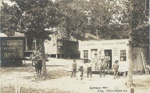 Historic black-and-white photo of a general store in Garber, Missouri, with people and a horse outside.