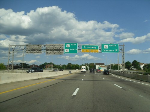 Highway scene with signs for Route 10 East, Route 10 North, and Route 10 South to Broadway and Cranston.