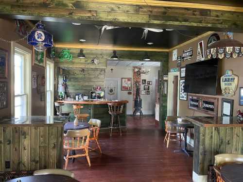 Cozy bar interior with wooden decor, stools, and various beer signs on the walls. A welcoming atmosphere.