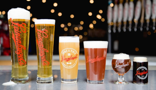 Five glasses of beer in various styles and colors, featuring the logo "Linenkugel's" on each glass.