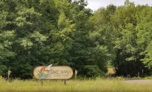 Sign for Lake Maria State Park surrounded by lush green trees and grass.