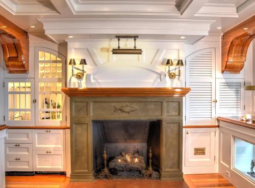 Cozy living room with a stone fireplace, wooden accents, and elegant lighting. Warm and inviting atmosphere.