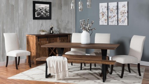A modern dining room featuring a wooden table, four chairs, a sideboard, and decorative wall art.