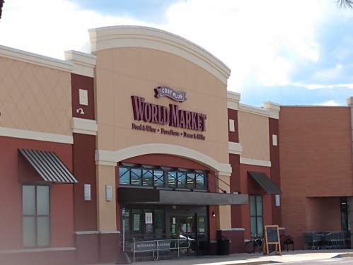 Exterior of a Cost Plus World Market store, featuring a large sign and entrance with shopping carts outside.