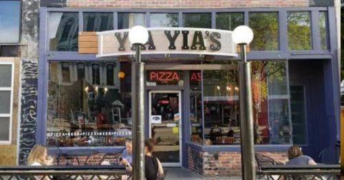 Exterior of Yia Yia's pizza restaurant, featuring a welcoming entrance and outdoor seating area.