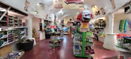 A colorful gift shop interior filled with various toys and souvenirs, featuring shelves and displays along the walls.