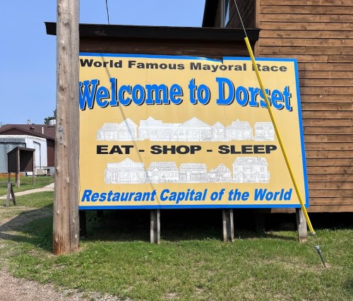 Sign welcoming visitors to Dorset, promoting it as the "Restaurant Capital of the World" with a mayoral race mention.