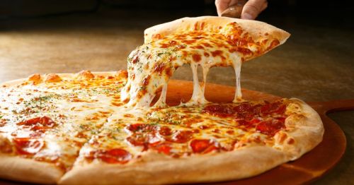 Pepperoni Pizza Slice close up with someone grabbing a slice with a spatula