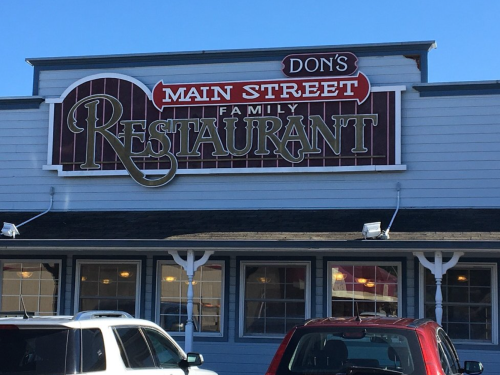 Sign for Don's Main Street Family Restaurant, featuring a classic design and bright colors on a sunny day.