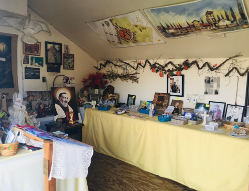 A cozy room filled with photos, religious artifacts, and decorations on tables and walls, creating a serene atmosphere.