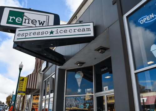 Sign for "re:new espresso ice cream" on a storefront, with an open sign and a colorful ice cream cone graphic.