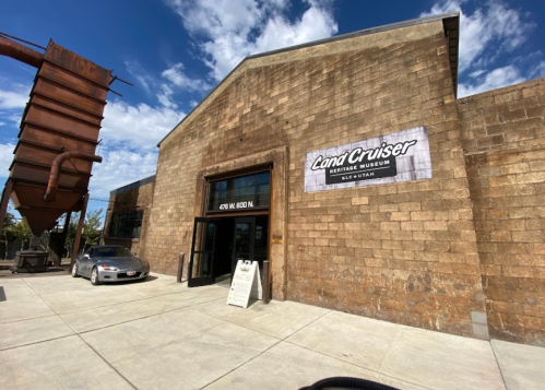 Exterior of the Land Cruiser Heritage Museum in Salt Lake City, featuring a stone building and a sign above the entrance.