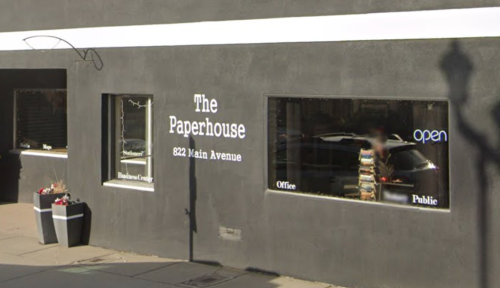 Exterior view of The Paperhouse, a business on Main Avenue, featuring large windows and an "open" sign.