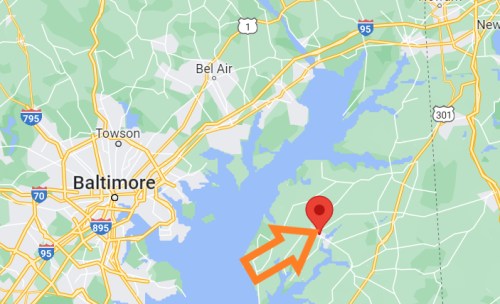Map showing Baltimore area with a red marker indicating a specific location, highlighted by an orange arrow.