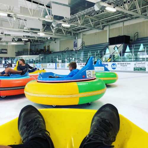 A group of people in colorful inflatable tubes enjoying a fun activity on an ice rink.