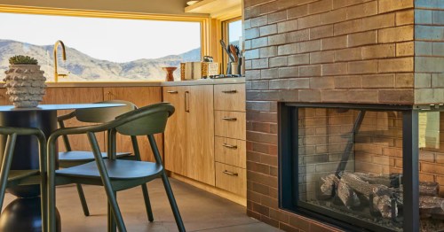 The kitchen and dining area of one of the best cabins in Southern California with a view looking out toward the mountains.