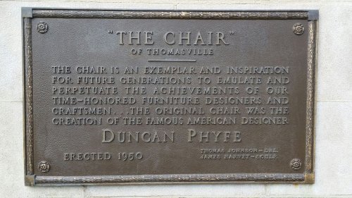 Bronze plaque honoring "The Chair" of Thomasville, highlighting its design legacy and creator Duncan Phyfe, erected in 1950.