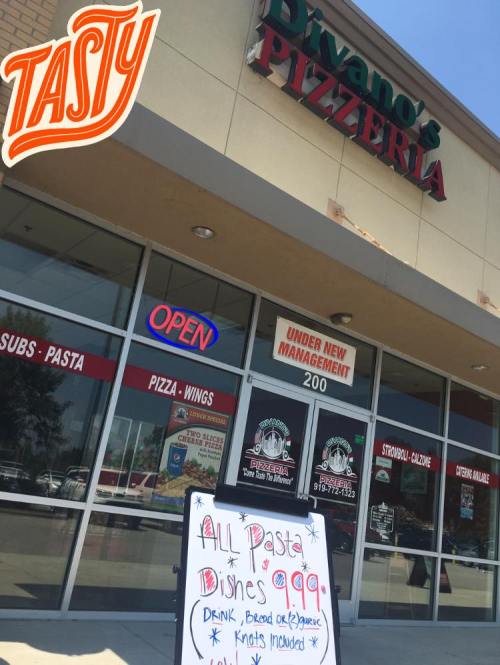 Exterior of Divano's Pizzeria with a sign advertising all pasta dishes for $9.99, featuring "Tasty" in the corner.