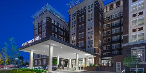 The exterior of the Cottonwood Hotel at dusk, featuring a modern entrance and stylish architecture.