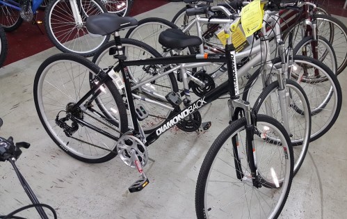 A black Diamondback bicycle displayed among other bikes in a shop.