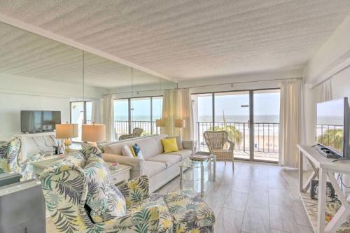 Bright beachside living room with large windows, tropical decor, and a view of the ocean. Cozy and inviting atmosphere.