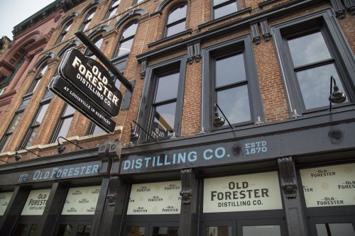 Exterior of Old Forester Distilling Co. building, featuring brick architecture and a prominent sign. Established 1870.