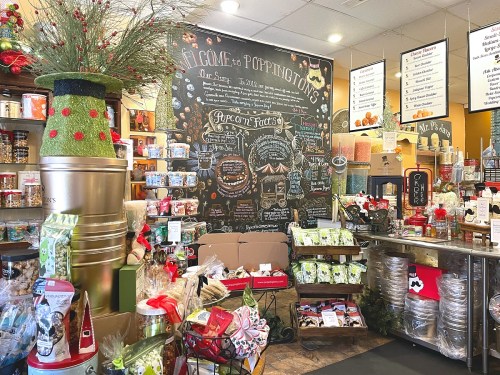 A cozy shop interior filled with festive decorations, snacks, and a chalkboard menu. Holiday spirit is in the air!