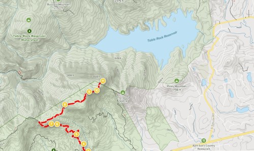 Map showing a hiking trail marked in red, surrounding Table Rock Reservoir, with elevation contours and nearby roads.