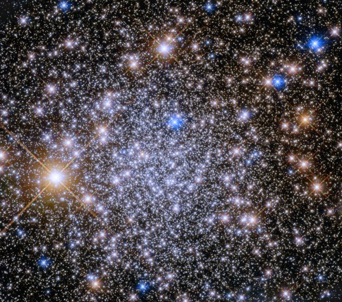 A vibrant star cluster filled with countless bright stars against a dark cosmic background.