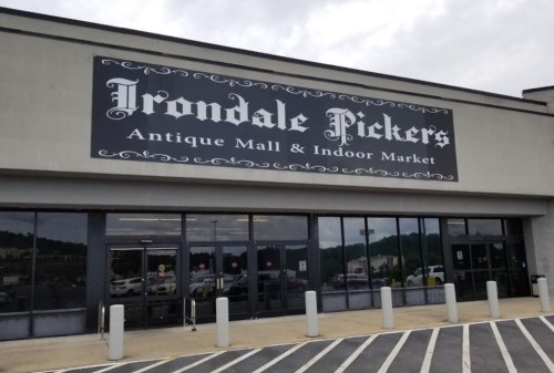 Exterior of Irondale Pickers Antique Mall & Indoor Market, featuring a large sign and parking area.
