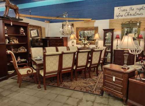 A cozy furniture showroom featuring a dining table set, lamps, and decorative items against a blue wall.