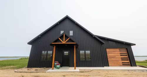 exterior of a modern cabin with a garage in ashley north dakota