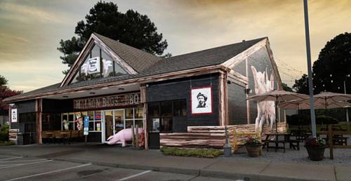 A rustic barbecue restaurant with a large pig mural, outdoor seating, and a welcoming entrance.