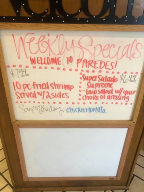 Weekly specials board at Paredes featuring fried shrimp, Super Salad, and chicken tortilla soup.